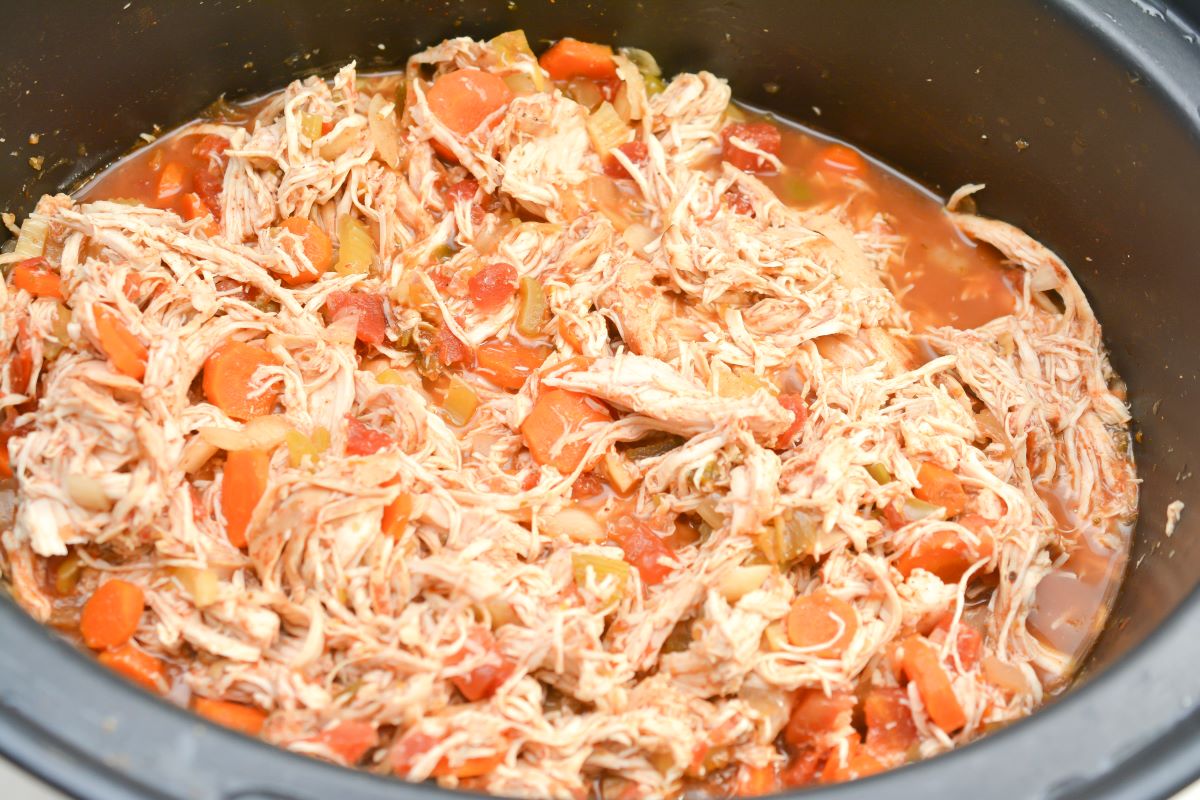 Shredded chicken and carrots in the crockpot.