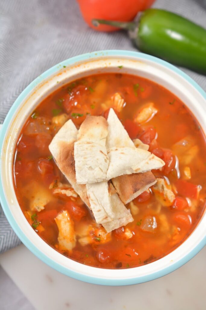 Chicken and tortilla soup in a bowl.