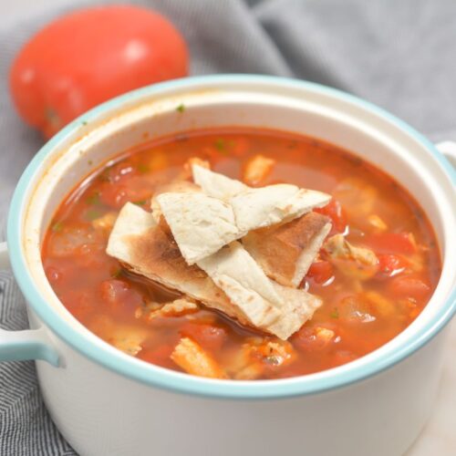 Chicken and tortilla soup in a bowl.