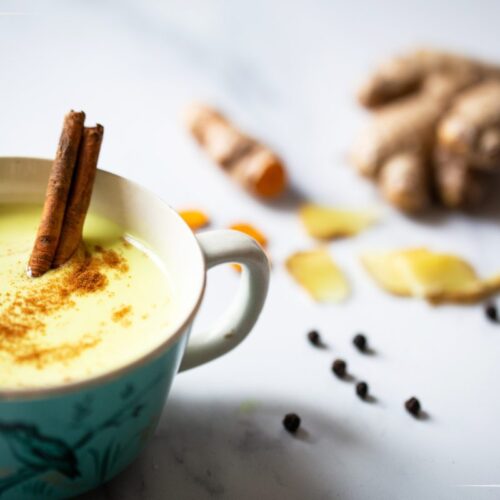 Golden Milk in a cup with cinnamon.