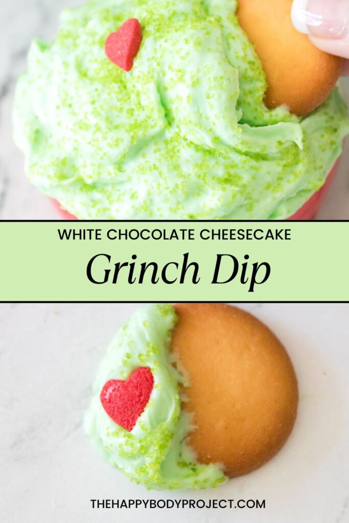 A creamy green dip topped with a red heart-shaped decoration, served with a vanilla wafer. It is labeled as "White Chocolate Cheesecake Grinch Dip" and has a website name, thehappybodyproject.com, written on it.