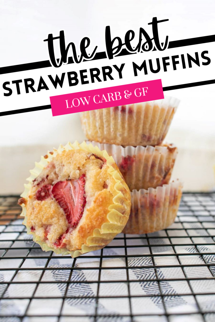 A stack of three strawberry muffins on a wire rack with one muffin in the foreground, partially revealed to show strawberries inside. Text reads "The Best Strawberry Muffins" and "Low Carb & GF" on the image.