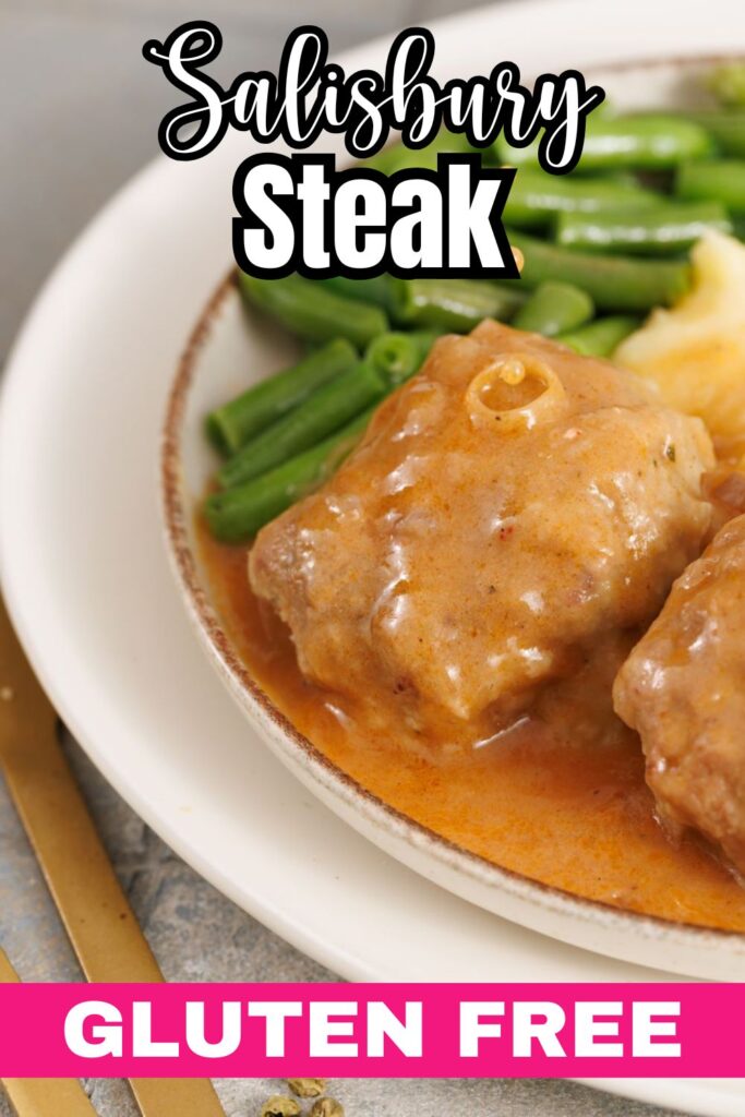 A plate of Salisbury steak with gravy, mashed potatoes, and green beans, labeled "Gluten Free." Gold cutlery is visible beside the plate.