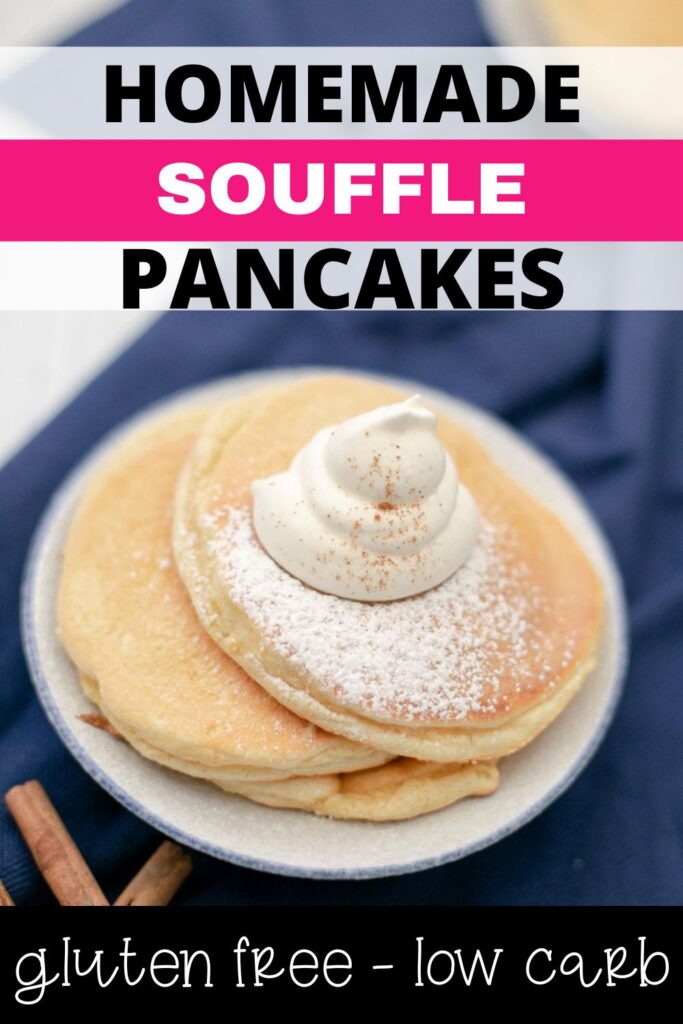 A plate with two fluffy souffle pancakes topped with a dollop of whipped cream and a dusting of powdered sugar. A cinnamon stick and a navy blue cloth are in the background. Text above reads "Homemade Souffle Pancakes" and below "gluten free - low carb.