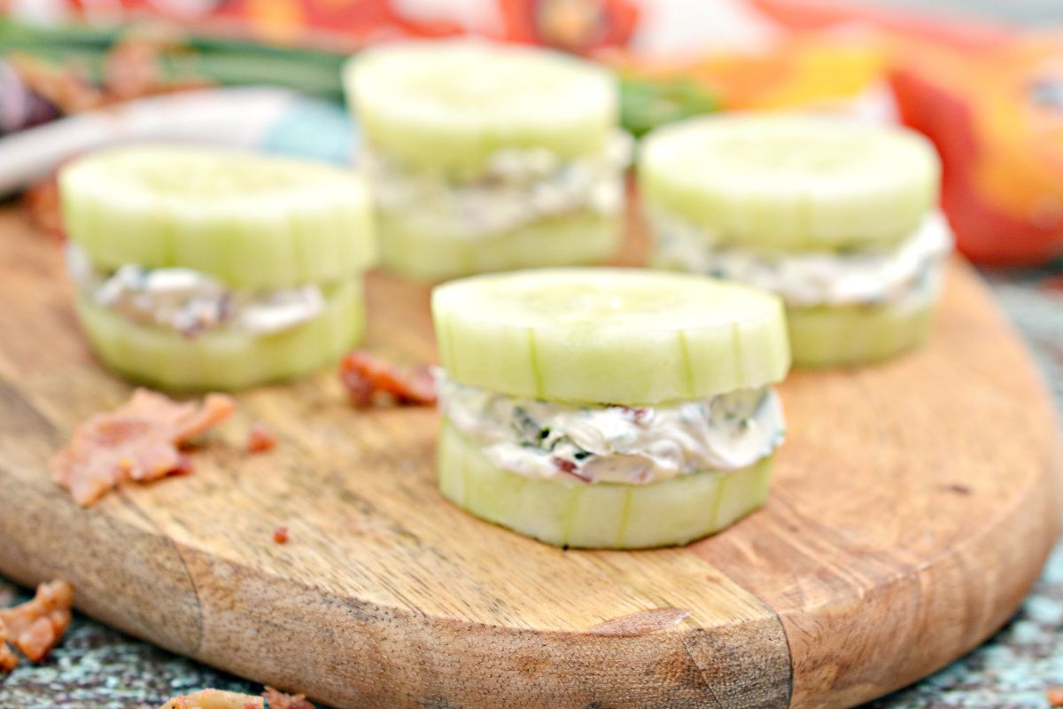 Cucumber bites on a wooden plate.
